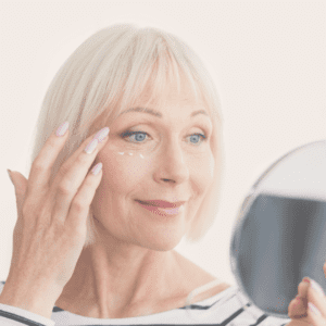 Woman looking in the mirror after seeing the advantages of botox treatment