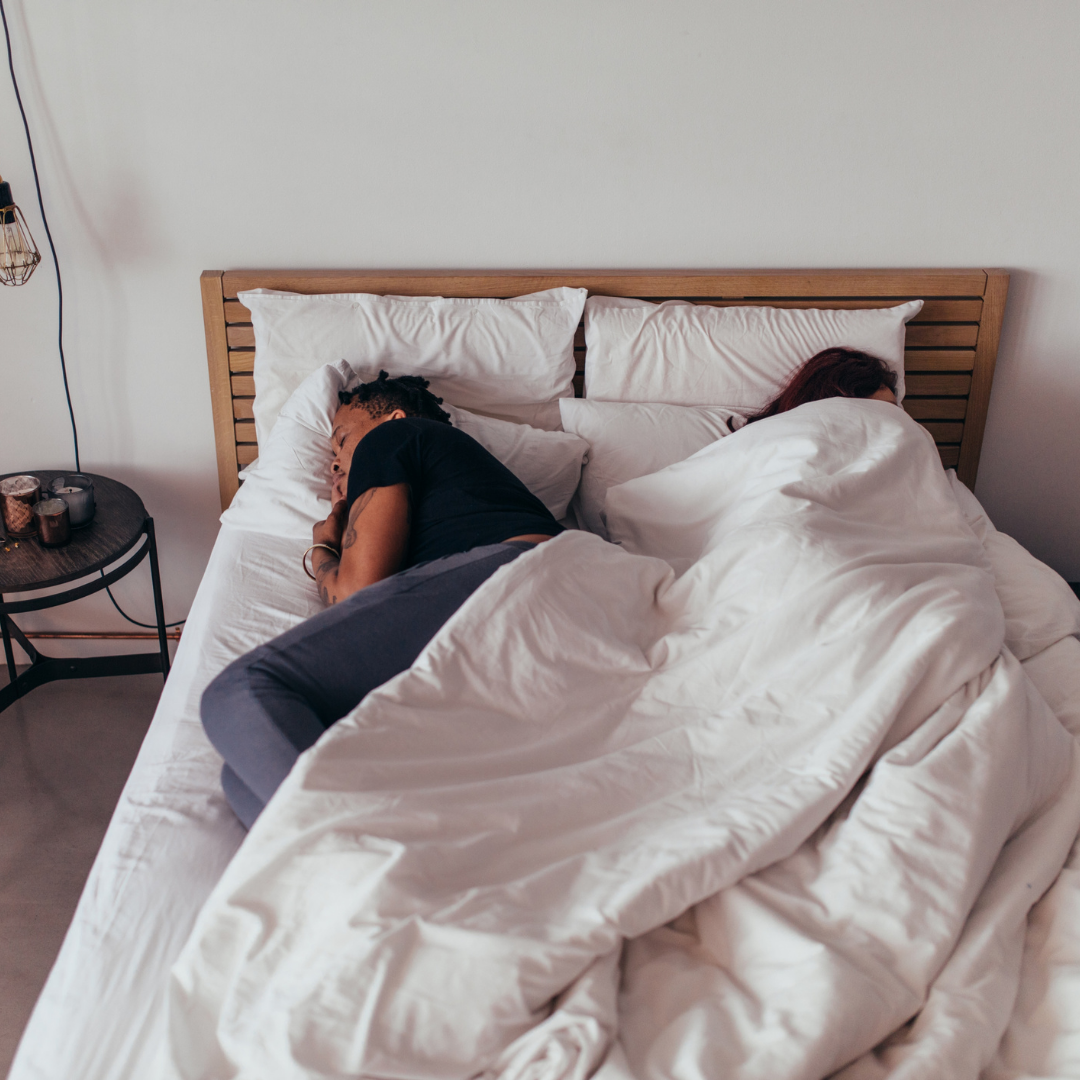 Two people in bed worried about low libido