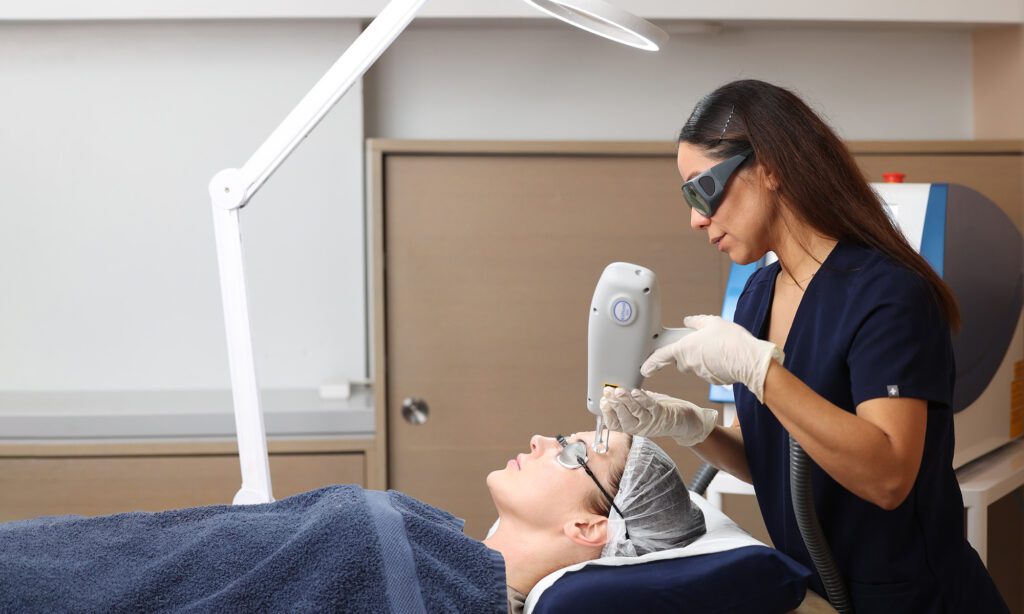 image of patient having fractional laser treatment with skin specialist at Omniya Clinic