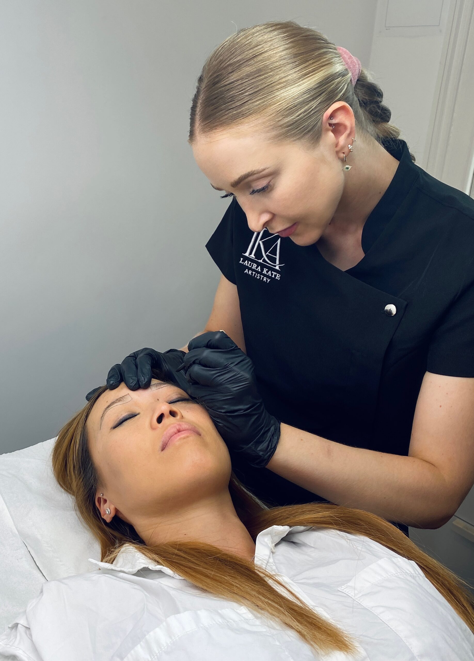 Beauty specialist performing Semi Permanent brows treatment at Omniya Clinic London