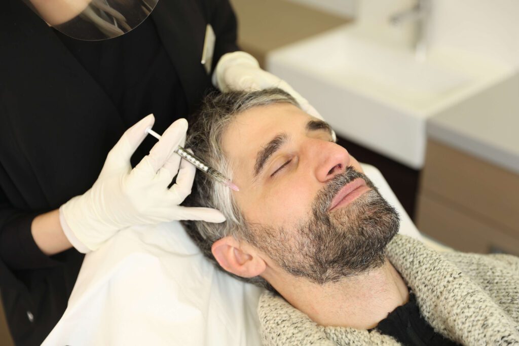 dr thu linh performing botox on a male patient